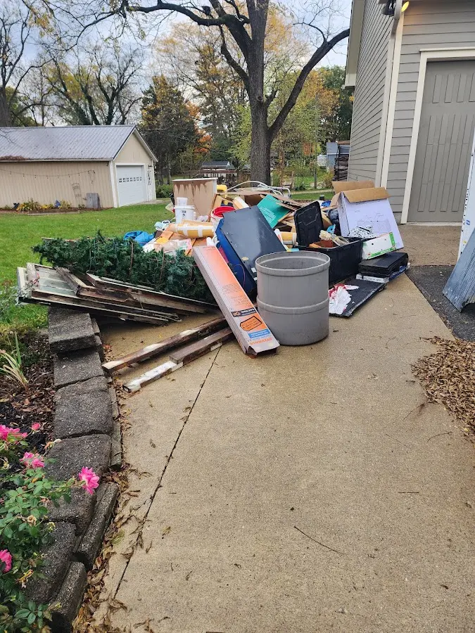 Dumpster being loaded with debris for Estate Cleanout Dumpster Rental in Palmdale